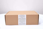 Closed brown cardboard box packaging for women's makeup kit with product label on white background