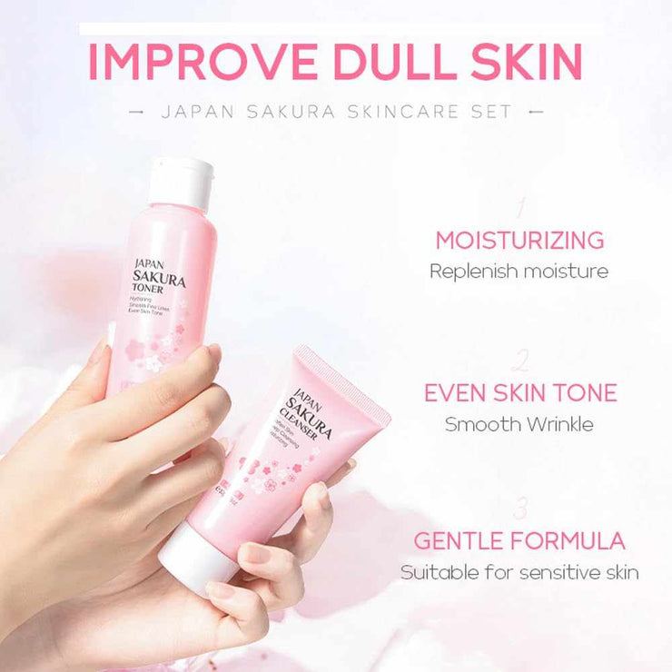 Hands holding Japan Sakura skincare kit toner and cleanser tubes with pink floral packaging for moisturizing and even skin tone
