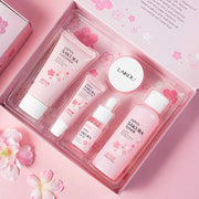 Sakura skincare kit 5-piece travel set with cleanser, toner, serum, eye cream, and face cream in pink floral packaging