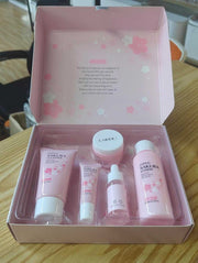 Sakura skincare kit 5-piece travel set with cleanser, toner, serum, eye cream, and face cream in pink packaging