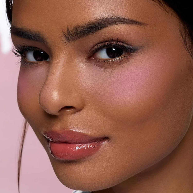 close-up of woman wearing Butterfly Cloud Collar Rouge Box blush and highlighter duo powder with pink matte finish on cheeks