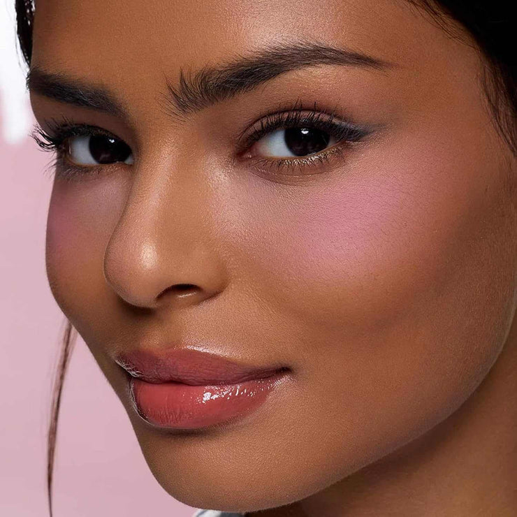 close-up of woman wearing Butterfly Cloud Collar Rouge Box blush and highlighter duo powder with pink matte finish on cheeks