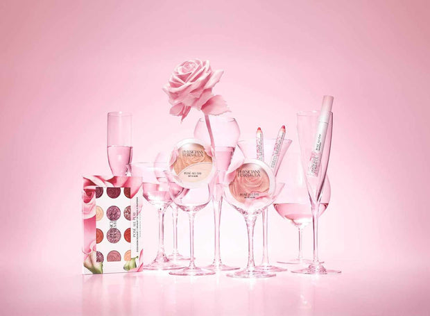 Rosé All Day Set glamorous lip and cheek makeup collection with pink tones and elegant packaging displayed with pink rose and glassware