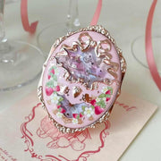 Strawberry Rococo Embossed Blush compact with intricate floral and bow design in pink and gold tones