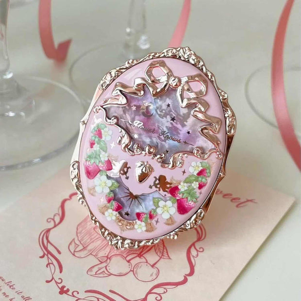 Strawberry Rococo Embossed Blush compact with intricate floral and bow design in pink and gold tones