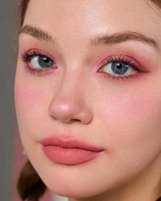 Close-up of a woman wearing pink eyeshadow, blush, and lipstick from the Strawberry Cupid Makeup Palette S02 Cupid's Mischief with matte and shimmer finishes.