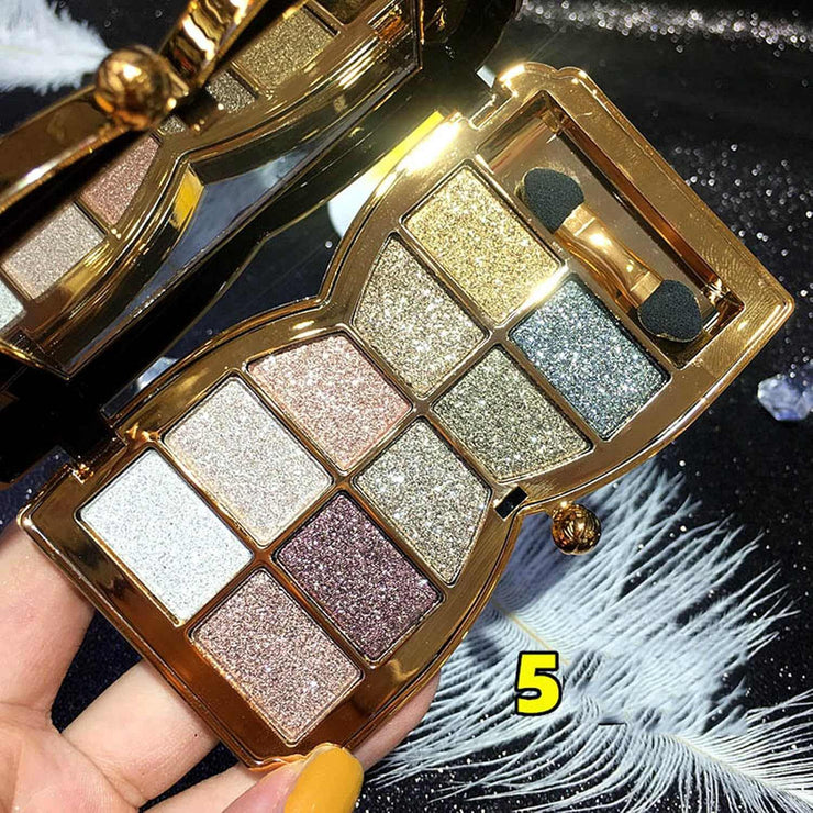 10-color glitter eyeshadow palette with gold tones, shimmer, sparkle, and long-lasting waterproof formula in a compact case with applicators