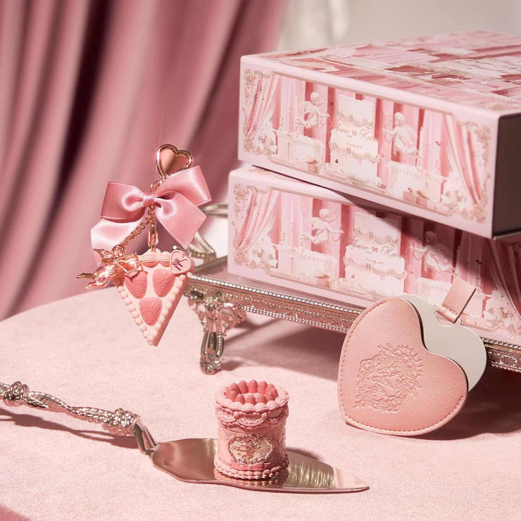 Strawberry Cupid Makeup set with pink heart-shaped compact, decorative box, and ornate applicator on pink velvet background