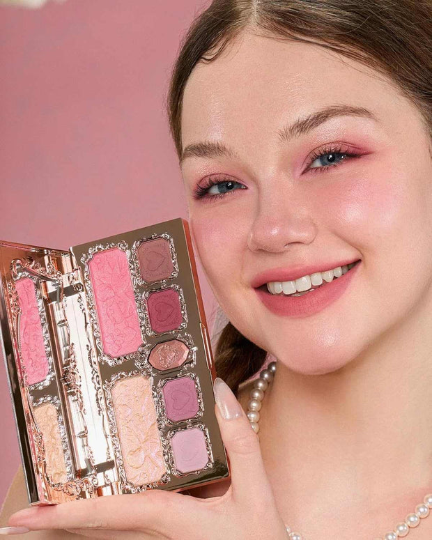 Smiling woman holding Strawberry Cupid Makeup palette with pink and mauve shades on cheeks and eyes