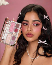 Woman with pink eyeshadow and blush holding Strawberry Cupid Makeup Palette with pink matte and shimmer shades