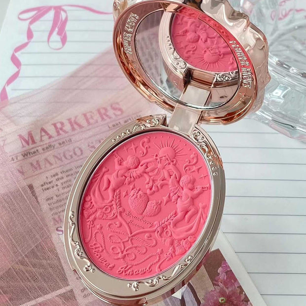 Strawberry Rococo Embossed Blush compact with intricate rose gold design and pink embossed powder for radiant cheeks