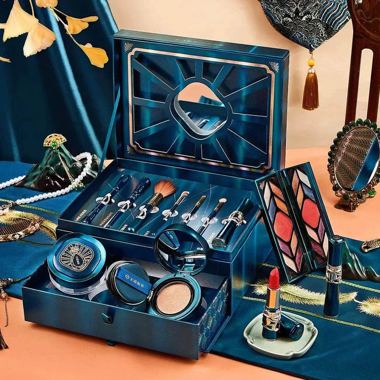 12-piece luxury makeup gift set with BB cushion, eyeshadow palette, brushes, lipstick, and compact powder in elegant blue packaging