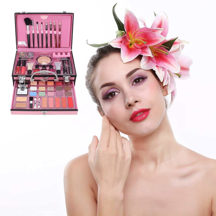 Full makeup kit with brushes and cosmetics in pink case alongside woman with floral headpiece and vibrant makeup